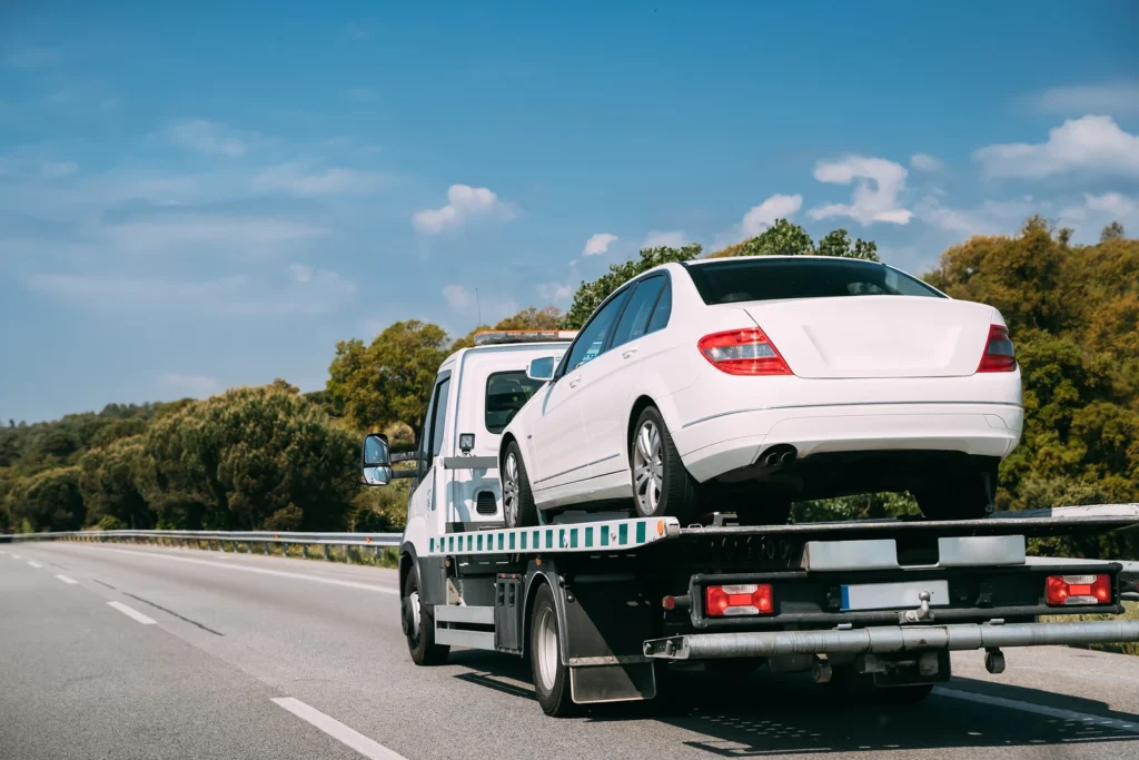 recovery truck taking damaged car